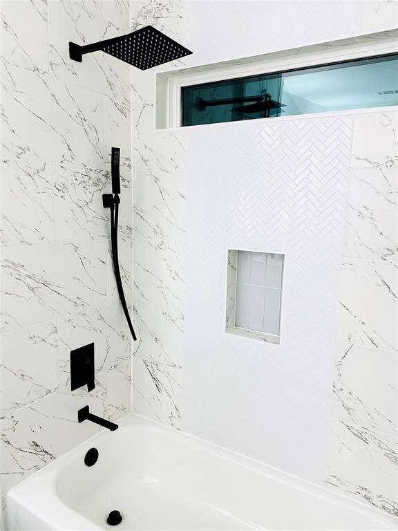 Wake up to a magazine worthy bathroom every morning featuring beautiful quartz countertops, LED backlit multi function mirrors, glass vanity vessel sinks, double stacked solid wood head knocker cabinets w/ soft close doors over the toilet, spa grade faucets and hardware plus more. Buyer can choose between brushed Nickel or Matte Black faucets and hardware.
