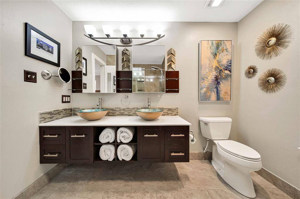The remodeled primary provides a spa-like feel with a floating dual vanity and other features.