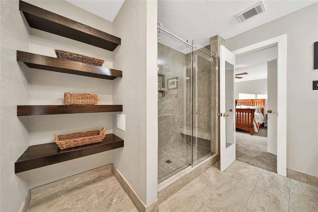 The bathroom also features built-in shelves for additional storage.