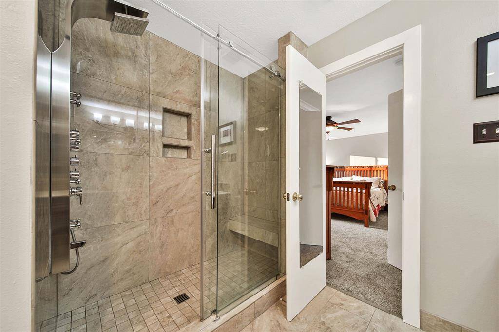 The updated oversized shower includes bench seating.