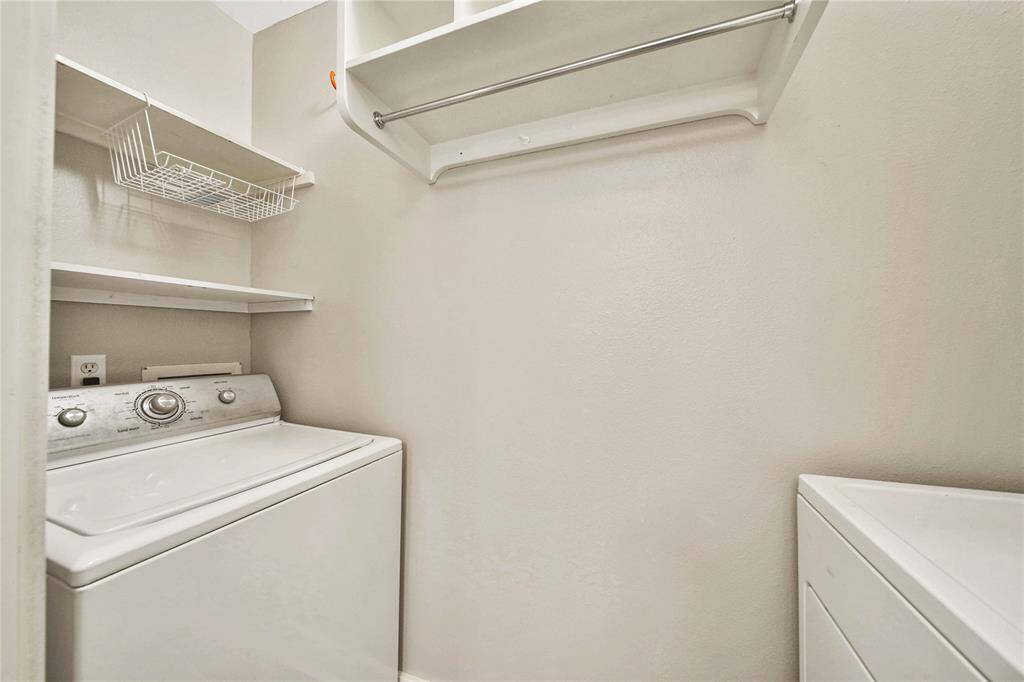 Downstairs utility room with washer and dryer.