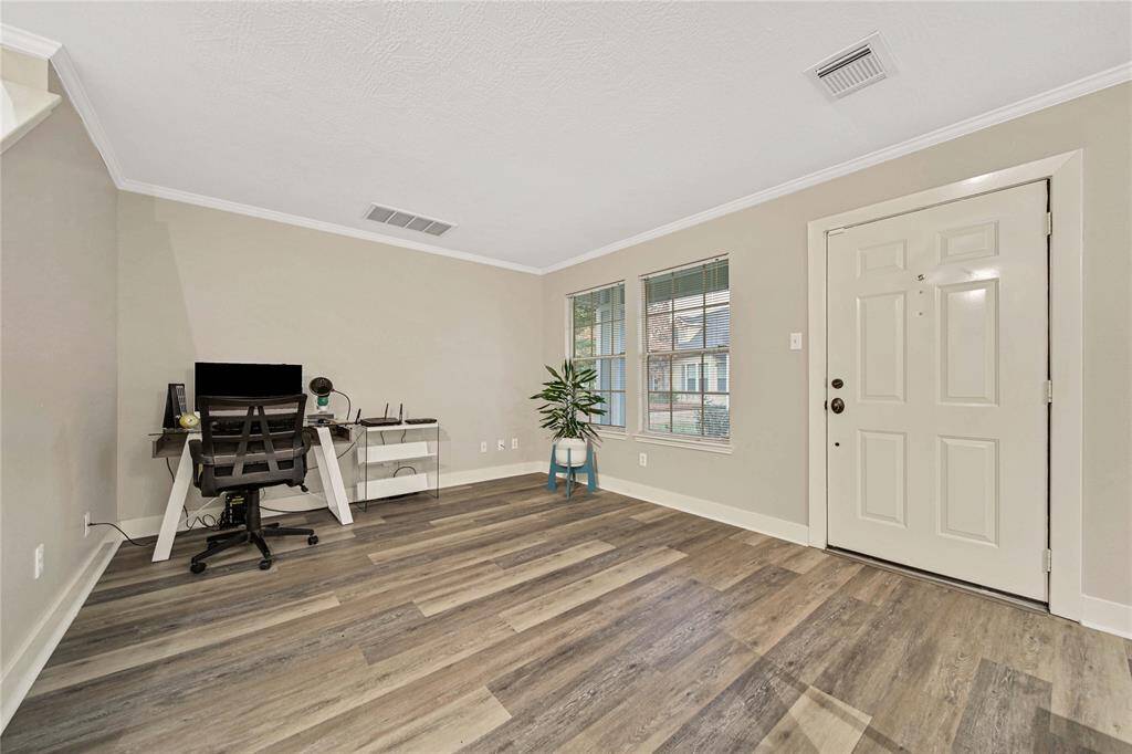 The formal living room/flexible space shown being used as an office.