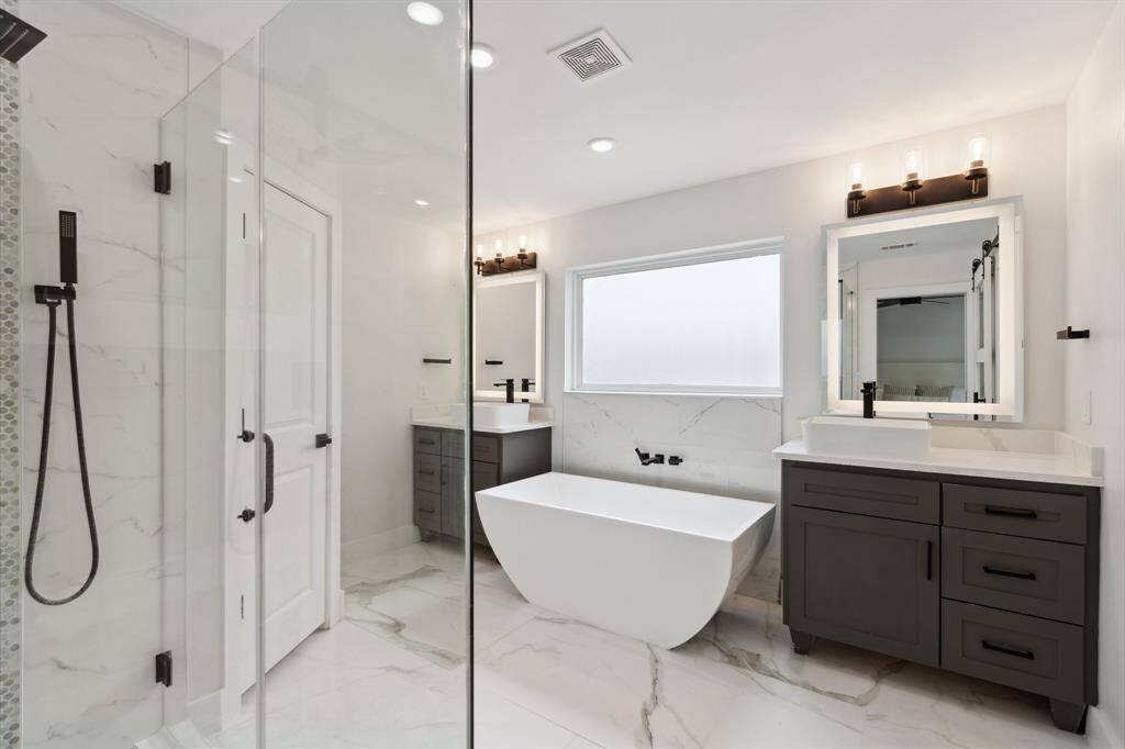 Gorgeous primary bathroom with double vanities.