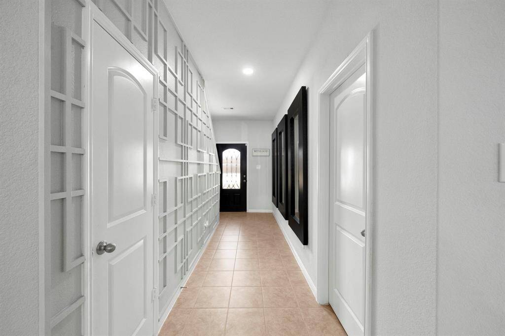 Another view of feature wall at foyer on the right is the half bath for guests.