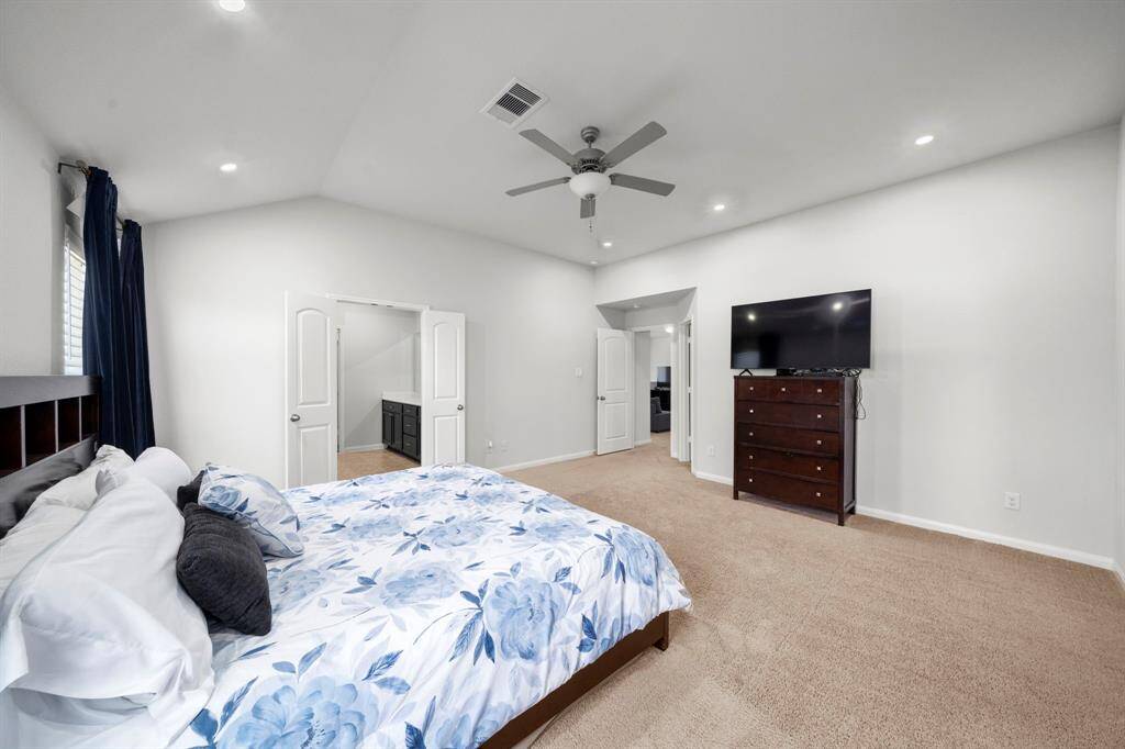 The primary bedroom has high ceilings.