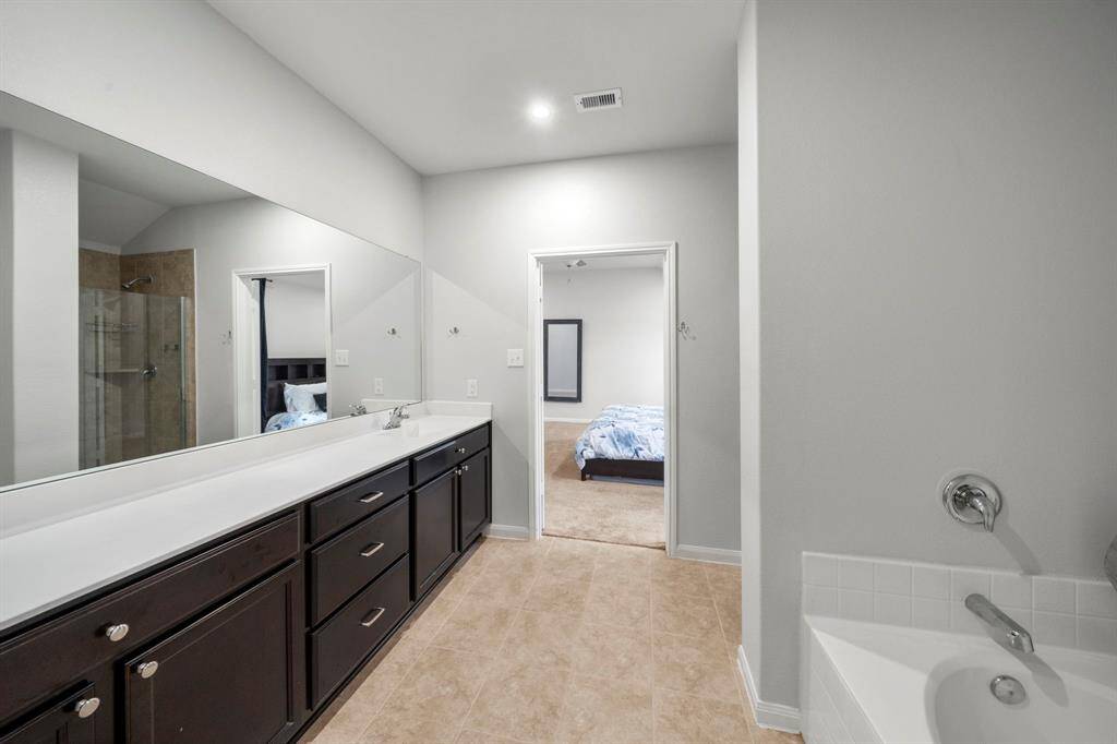 Another view of the primary bathroom looking into the bedroom.