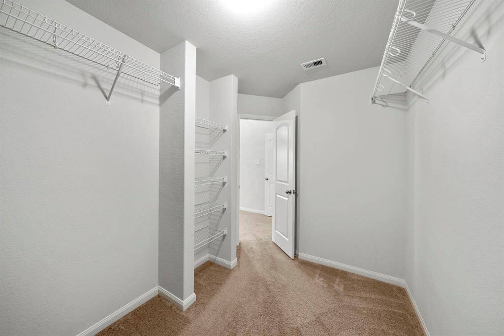 Large walk-in closet in the primary bedroom. There is another closet right across for all your storage needs.