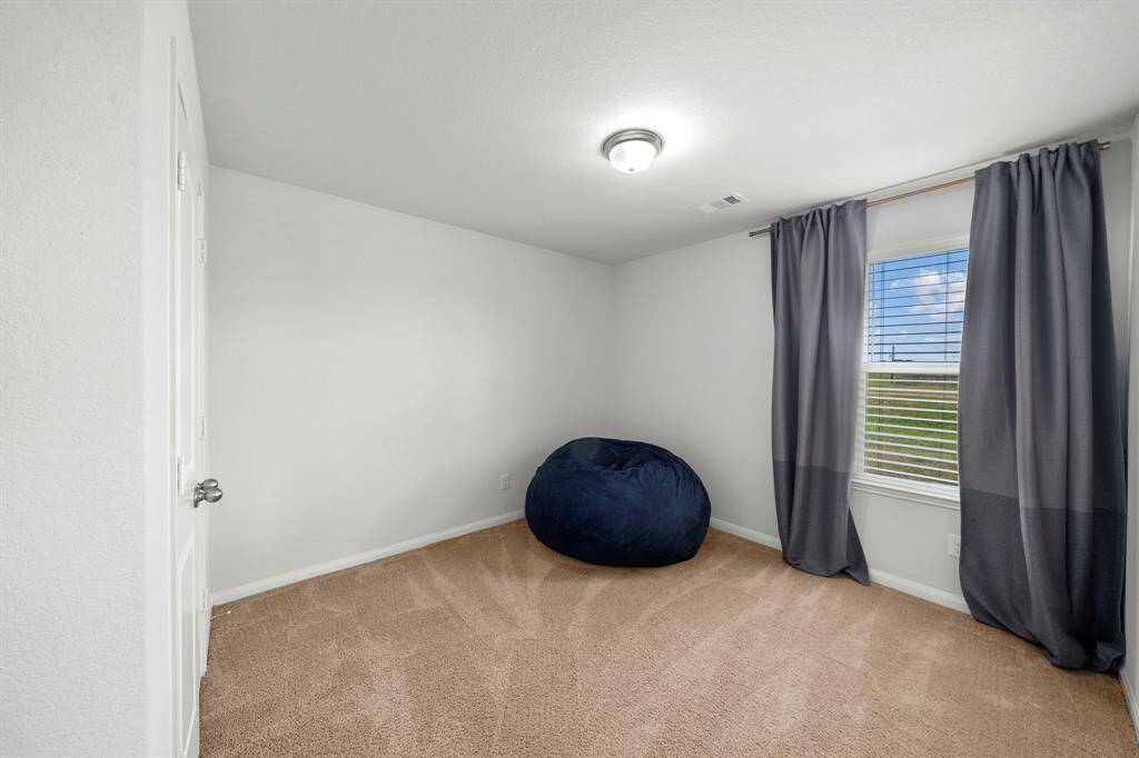 This is the 3rd secondary bedroom which overlooks the retention area next to the neighborhood. All secondary bedrooms have very spacious closets.