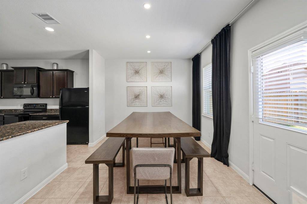 Large dining area with recessing lighting. overlooking the backyard. Please note back wall is now full of doors. Uploaded below.