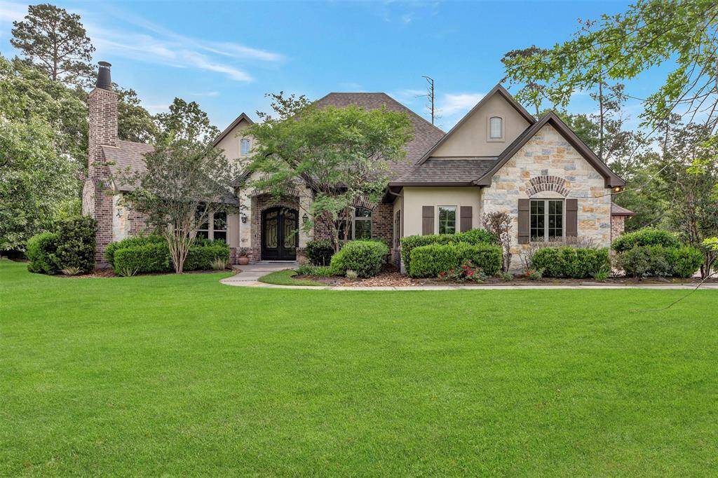 1.5 story home with a stone and brick exterior.
