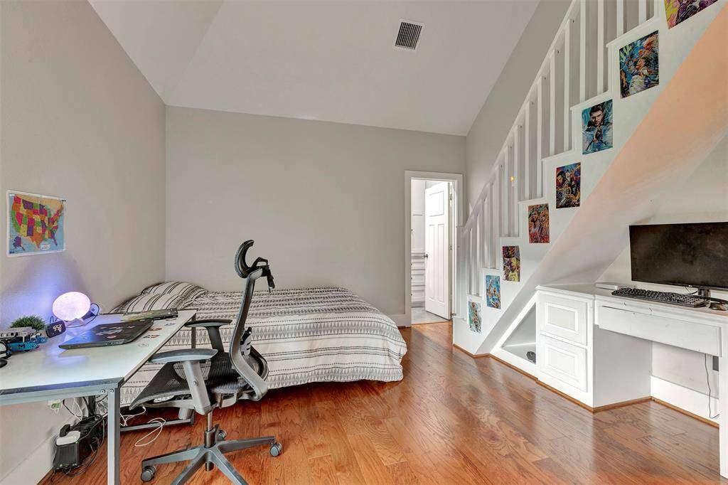 Guest Bedroom 2 with stairs up to a cozy loft area