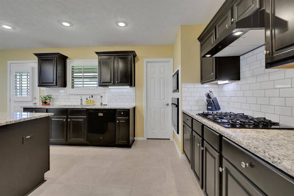 Huge kitchen with ample amount of cabinetry and a walk-in pantry.