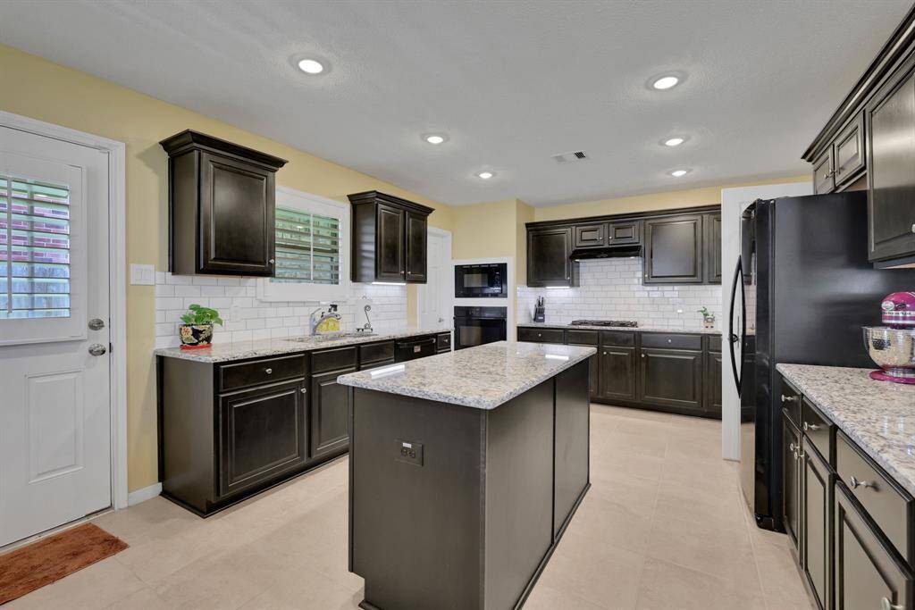 Huge kitchen with ample amount of cabinetry and a walk-in pantry.