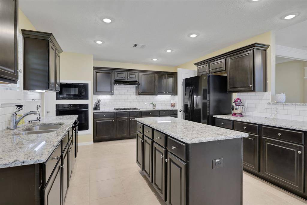 Huge kitchen with ample amount of cabinetry and a walk-in pantry.