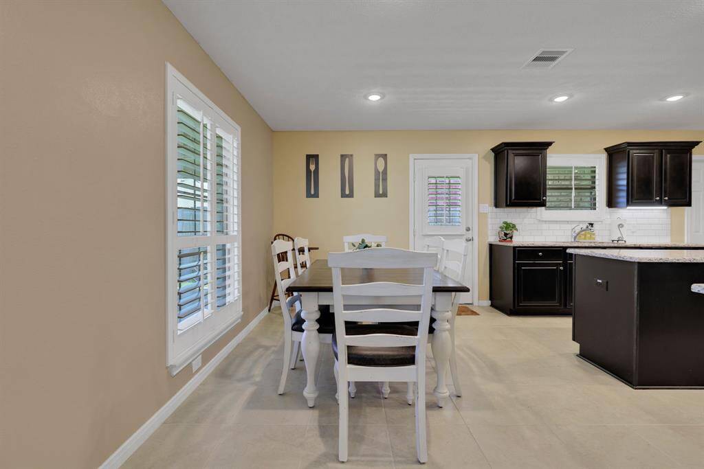 A nice sized breakfast area located by back door.