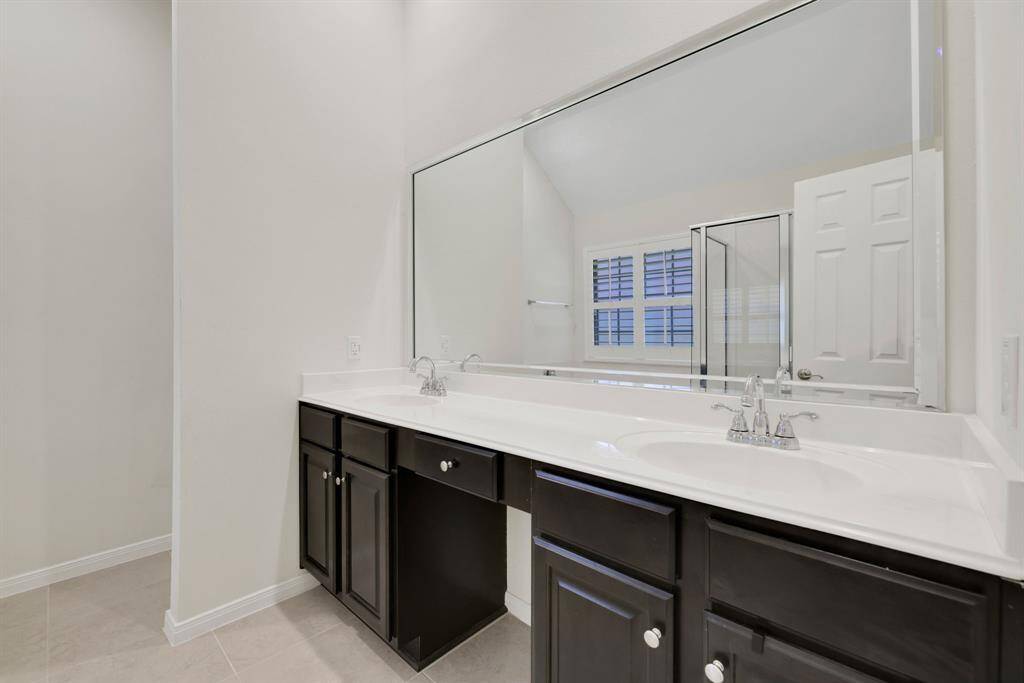 Primary bath featuring double sinks and private toiletry