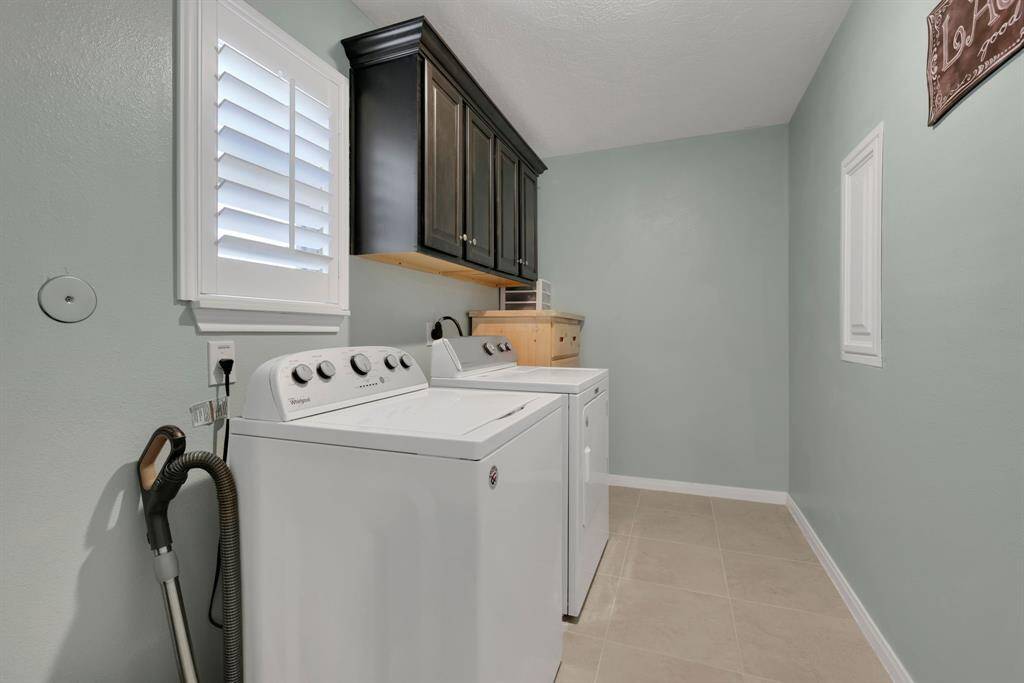 Laundry room with built-in cabinets and plenty of space to put an extra fridge and freezer!!