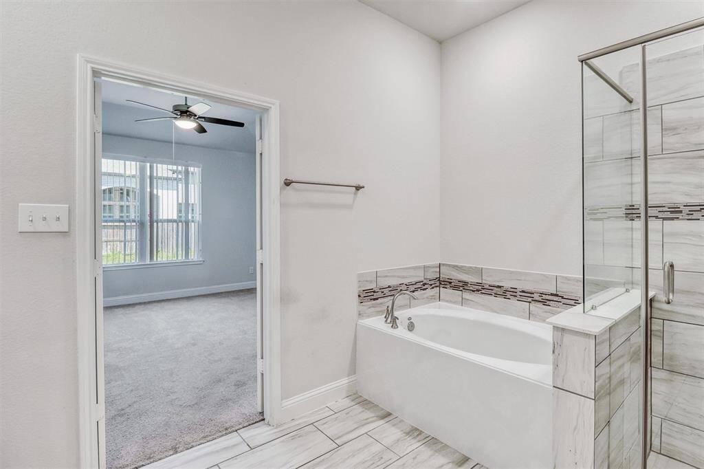 The Primary Bathroom features a large soaking tub, walk-in shower, and walk-in closet.