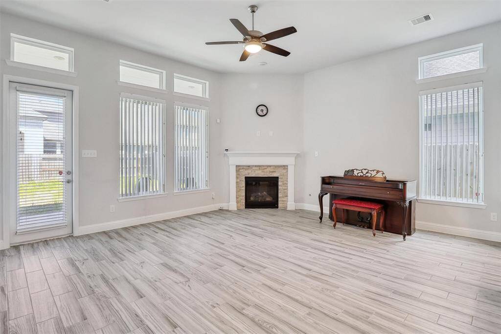 The Living Room offers plenty of natural light and a gas log fireplace.