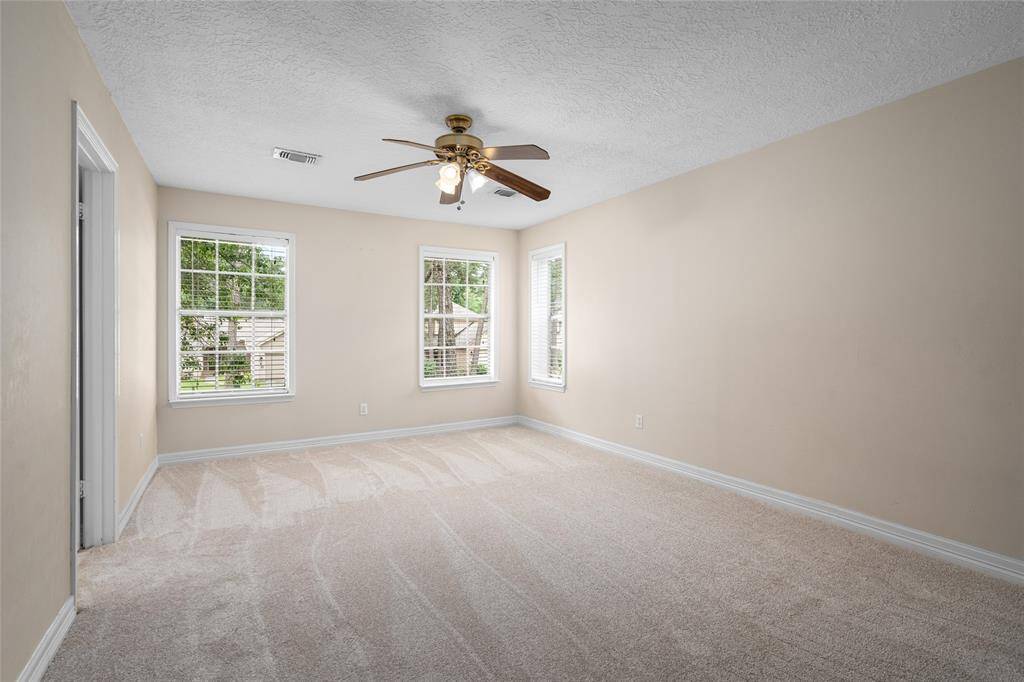 The spacious 2nd floor primary retreat includes an en-suite bath with view of the front lawn.