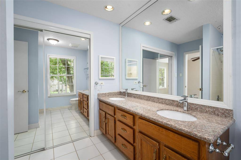 The primary retreat's en-suite bath with double sinks, walk-in closet and plenty of storage.