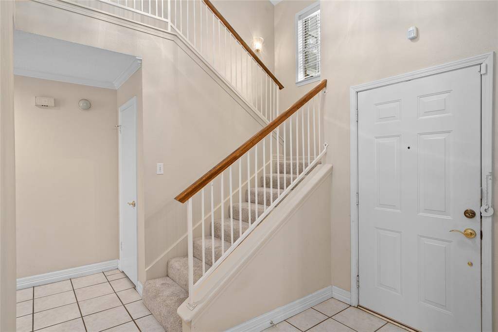 The foyer boasts a 2 story ceiling open to the loft game room above.