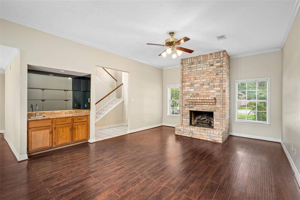 Your generously sized living room features a brick, gas log fireplace.