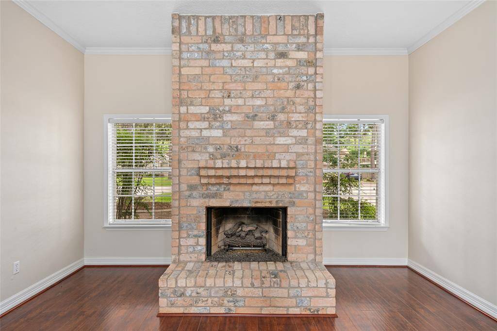 Another view of the gas-log, brick fireplace that creates an ideal focal point for the room.