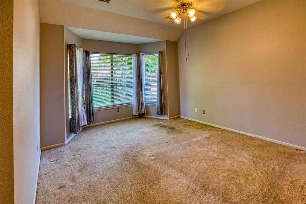 Primary Bedroom with Bay Window (yes, I need new carpet)