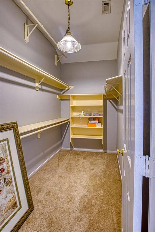 Primary Walk in closet with extra shelving