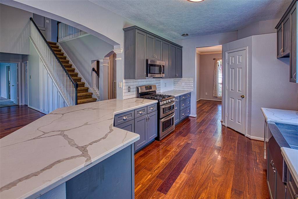Kitchen with Quartz Countertops, 5 burner gas cooktop and double oven