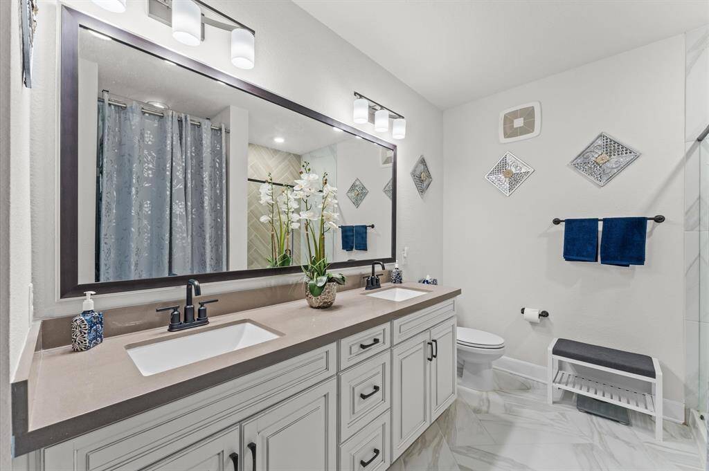 En suite layout with double sinks and spacious design, offering functionality and a strong foundation for personalization.