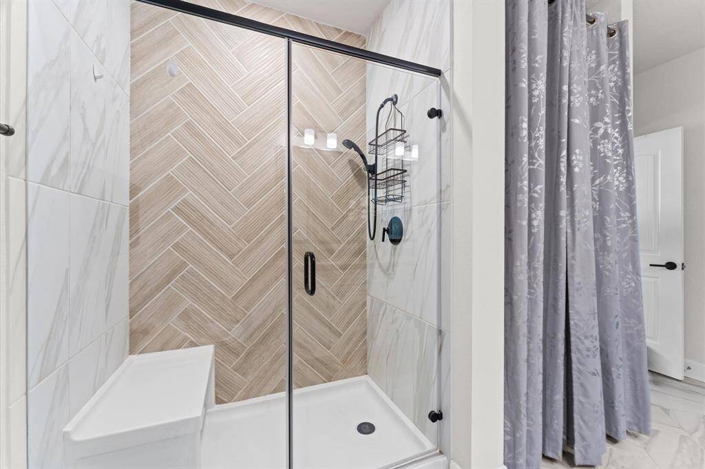 Spacious, glass-enclosed walk-in shower within the primary bathroom—designed for both comfort and future spa-like upgrades.