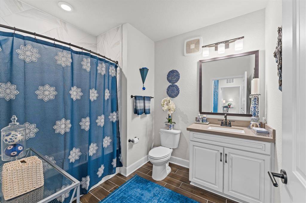 Thoughtfully positioned full bath with quality finishes, offering convenience for guests or roommates and flexibility for future use.