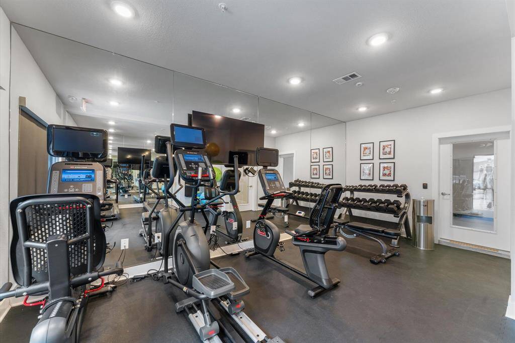 State-of-the-art fitness center equipped with cardio machines, free weights, and strength training equipment.