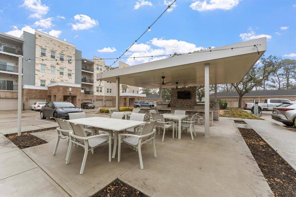 Resort-style outdoor kitchen and grilling station with covered seating, perfect for hosting barbecues and gatherings.