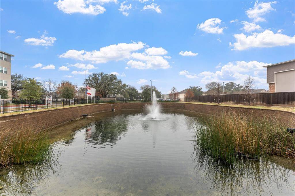 Serene pond with a walking path, providing a peaceful retreat within the community.