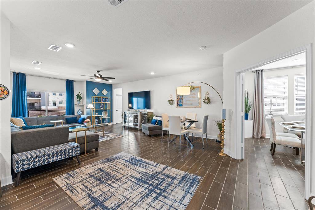 Beautifully designed open-concept living and dining area with abundant natural light and seamless flow into the adjacent flex room.