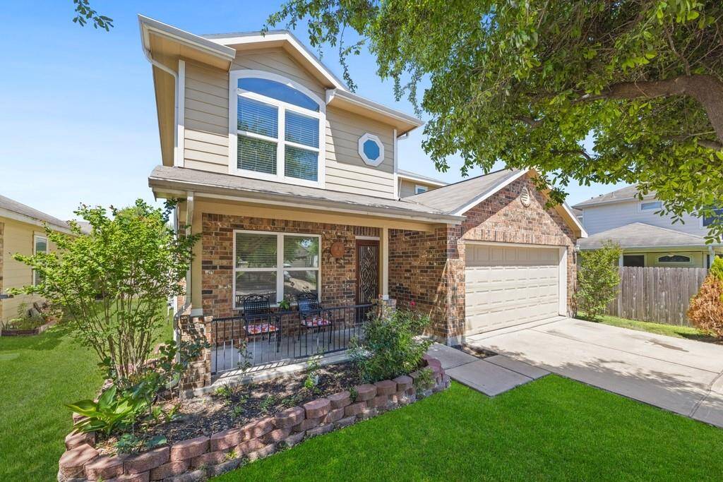 Double garage and mature trees offer shade and extra curb appeal.