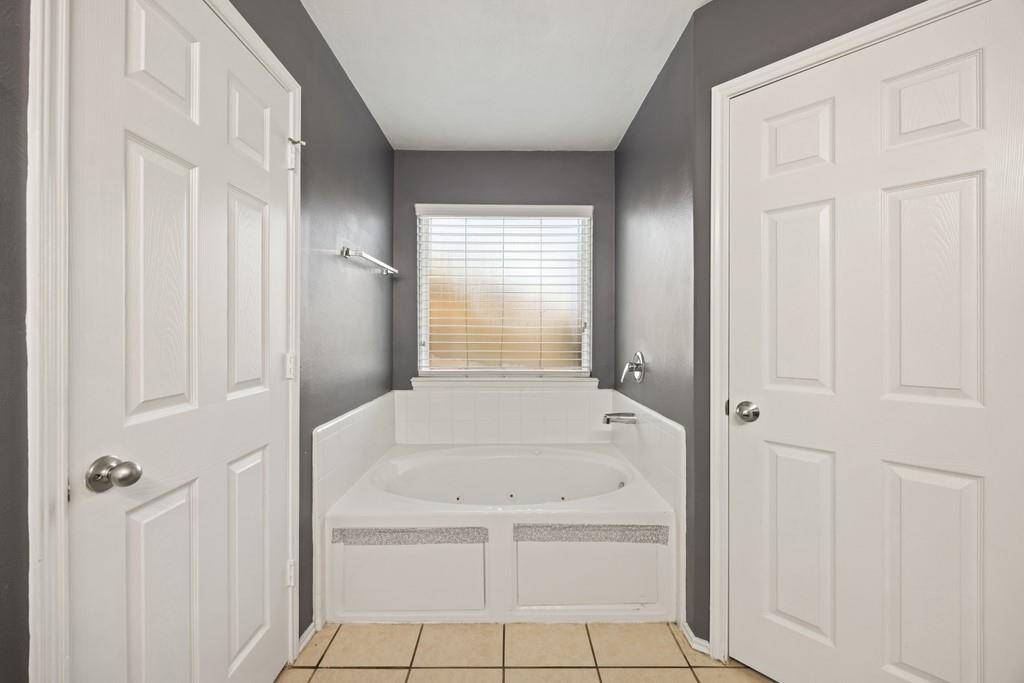 Separate tub and walk in shower in the primary suite.