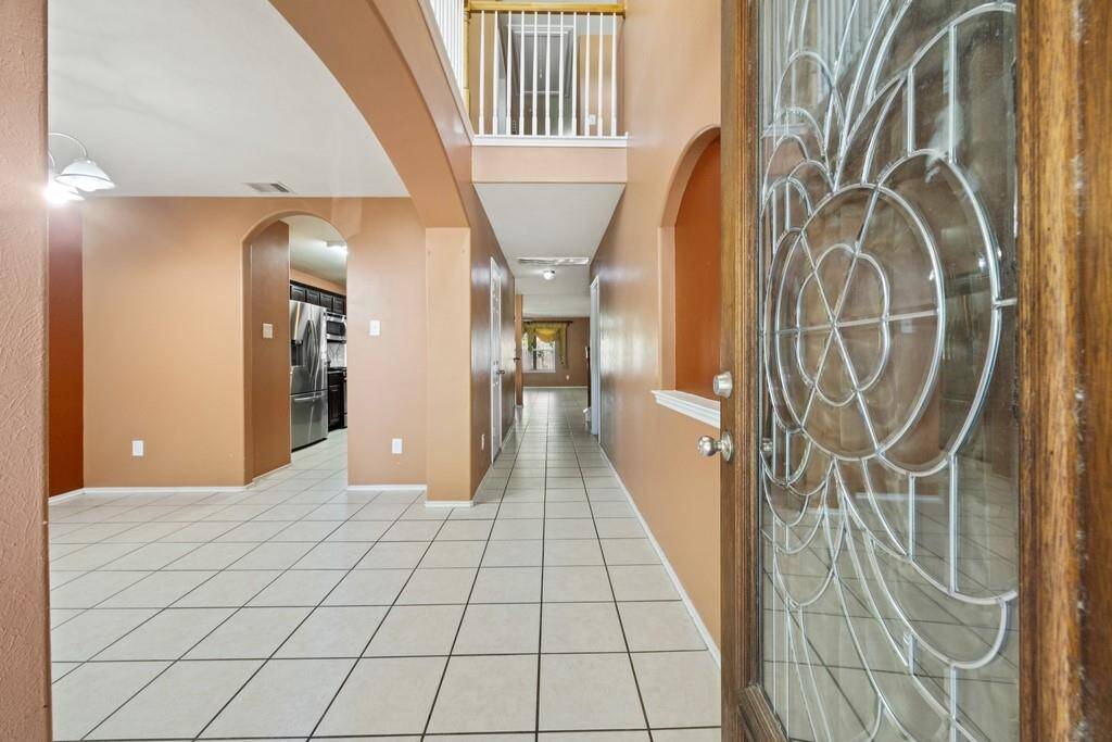 Spacious entry with high ceilings and beautiful natural light.