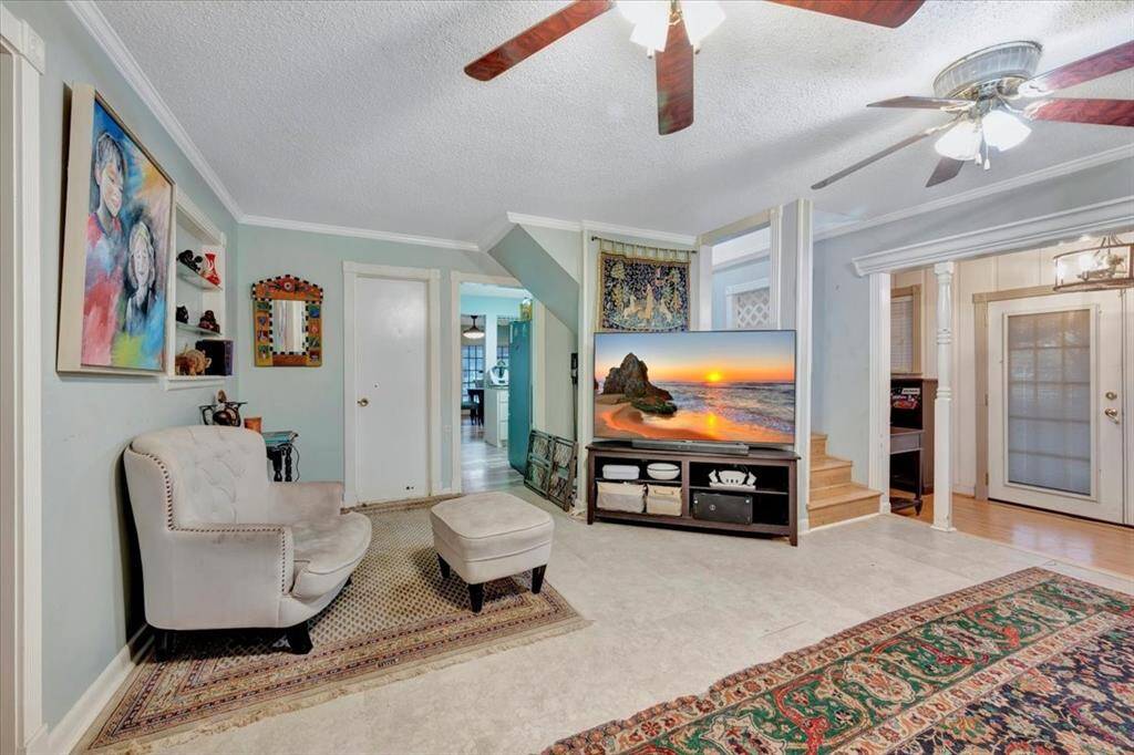 Spacious living room to enjoy time with the family detailed with built-in display cases and crown molding.