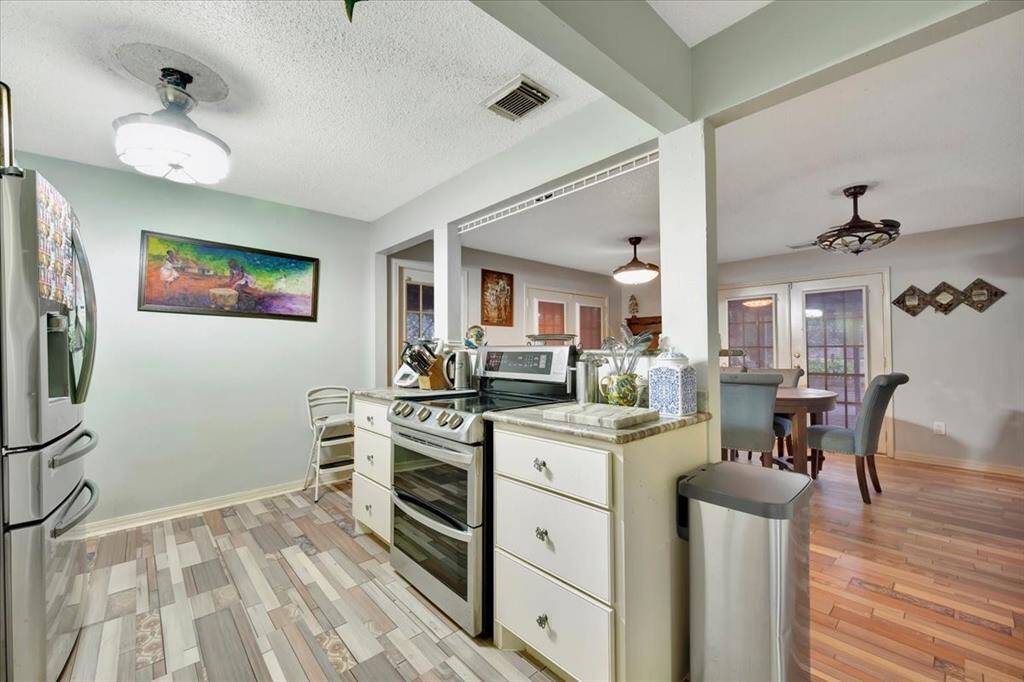 Recently remodeled kitchen with stainless steel appliances, granite countertops, and tile flooring.