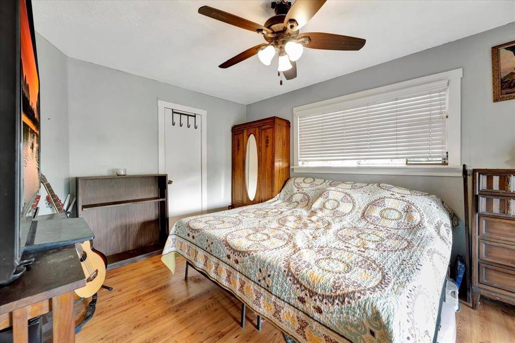 Primary en suite bathroom with granite countertops, brass bowl sink, and plenty of cabinet storage.