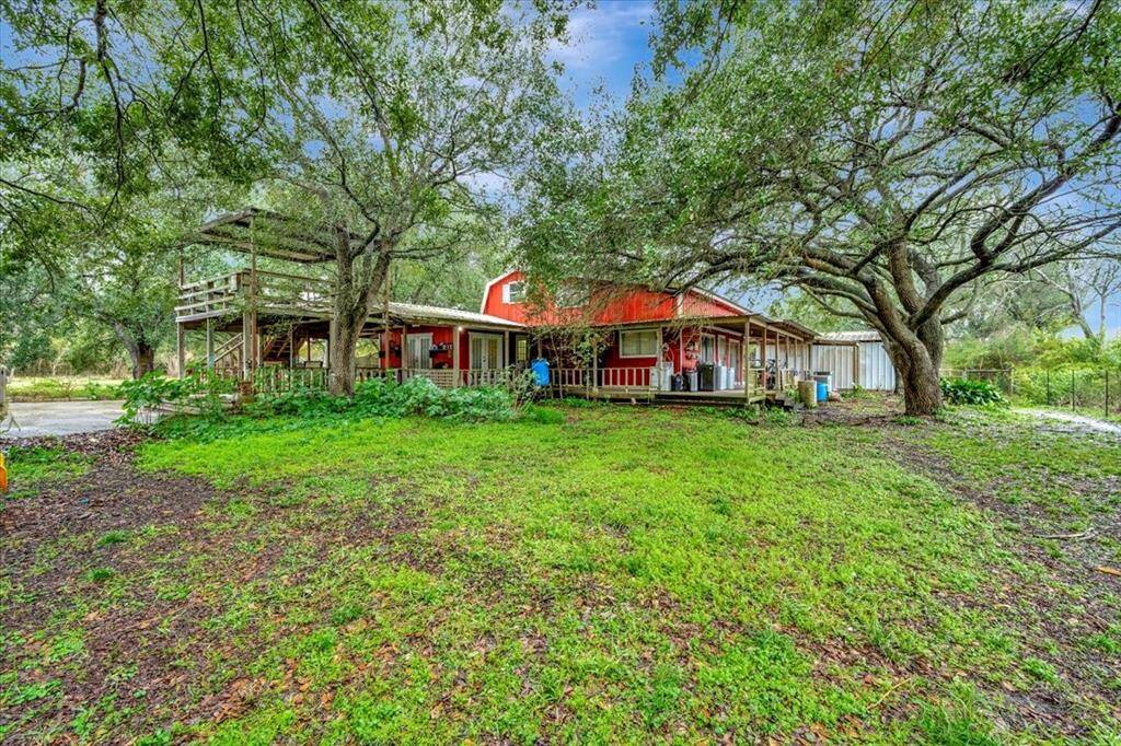 Extended driveway with 2 oversized bays for large trucks and farm equipment, with room for a shop.