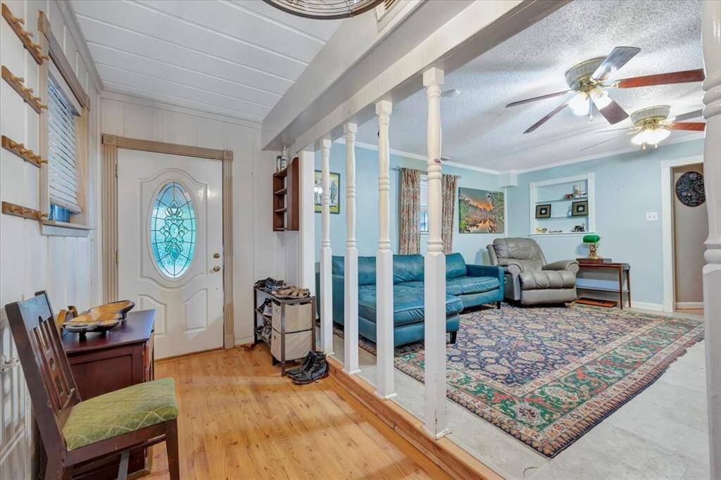 Classic country style in the entree way through the double glass doors with dustless blinds and wood floors.
