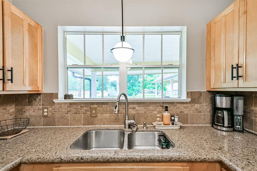 A moment that feels like home—preparing a meal in this heart-of-the-home kitchen while laughter floats in from the backyard and pool. With two large windows framing the view, you’re never far from the joy just outside.