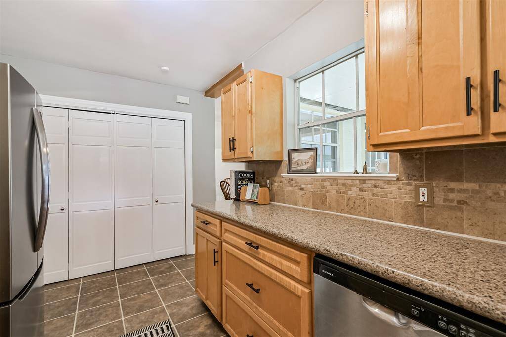 Tucked behind charming louvered doors along the back wall, a well-organized pantry offers the perfect blend of form and function—keeping everything within easy reach while maintaining a clean, classic look.