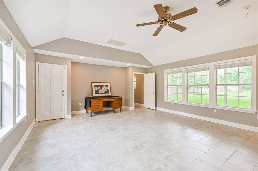 Step down into this expansive family room—filled with natural light from windows on two sides, soaring ceilings, and beautiful tile flooring that adds both style and durability.