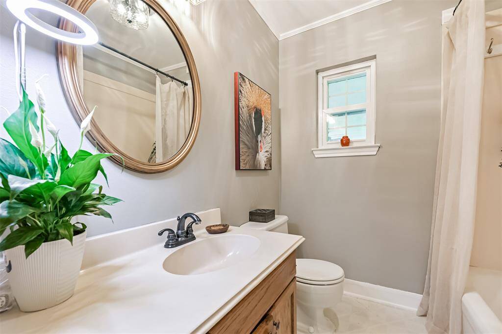 Serving the three downstairs bedrooms, this charming bathroom features a tub/shower combo, a window with views of the backyard, plenty of counter space, and ample storage. (Be sure to check out our Matterport 3D tour for the full look of this gorgeous home!)